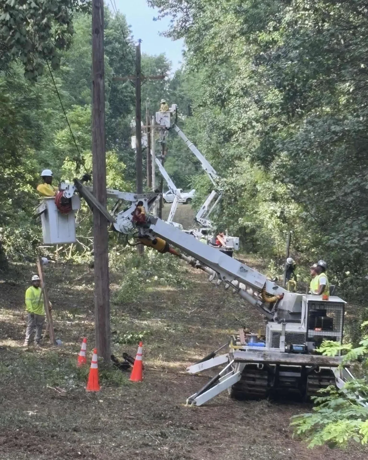 Multiple utility bucket crews working on overhead power lines