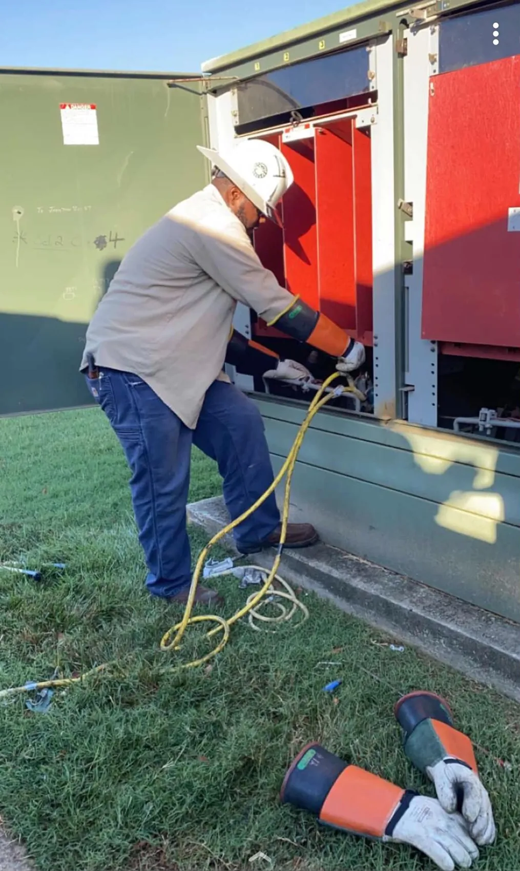 Utility worker servicing electrical equipment